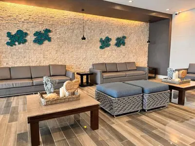a living room with couches and tables and a brick wall at Condo at Shore 1 with Netflix in Manila