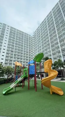 a playground in front of a large building at Condo at Shore 1 with Netflix in Manila