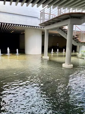a flooded building with fountains in the water at Ikigai's Alpha Makati City View Condo with Balcony Perfect for Relaxation in Manila