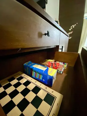 a box of games sitting next to a chess board at Ikigai's Alpha Makati City View Condo with Balcony Perfect for Relaxation in Manila