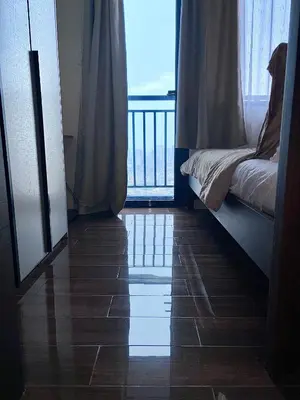 a room with a balcony with a bed and a window at Ikigai's Alpha Makati City View Condo with Balcony Perfect for Relaxation in Manila
