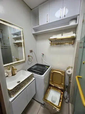 a small bathroom with a sink and a toilet at Hadisha Suite Spring Residence in Manila