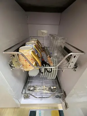 a drawer in a refrigerator filled with utensils at Hadisha Suite Spring Residence in Manila