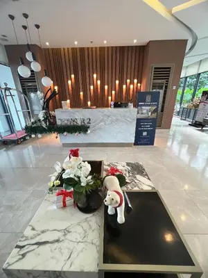 a lobby with a teddy bear and flowers on a table at Hadisha Suite Spring Residence in Manila