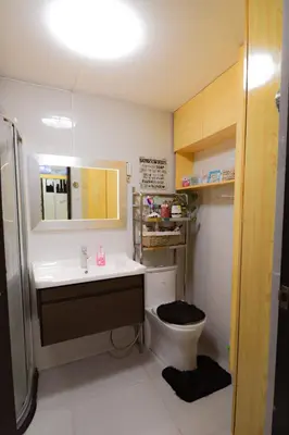 a bathroom with a toilet and a sink and a mirror at JP's Cityscape in Manila