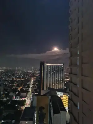 a view of a city at night with a building at JP's Cityscape in Manila