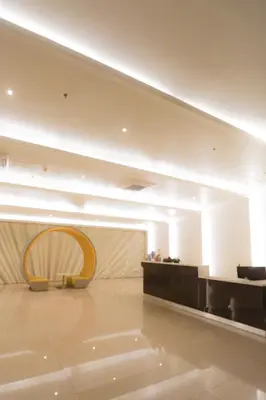 a large lobby with a table and a chair at JP's Cityscape in Manila