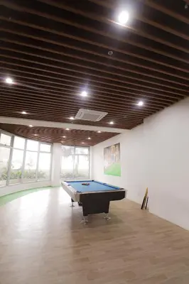 a pool table in a large room with a ceiling at JP's Cityscape in Manila