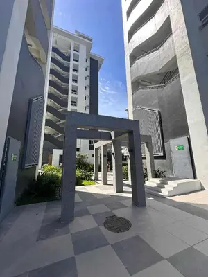 a sculpture in front of a building with tall buildings at The Finest Charm Residences by Ashti in Manila