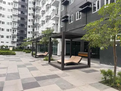 a row of benches in a courtyard in a building at The Finest Charm Residences by Ashti in Manila