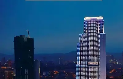 a tall building in a city at night at Gramercy Century City Makati in Manila