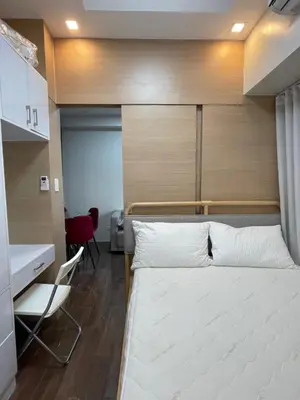 a bedroom with a bed and a desk and a chair at Beauty Cindrella Home Makati Penthouse 3 Bedroom in Manila