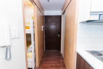 a hallway with a brown door in a bathroom at Beauty Cindrella Home Makati Penthouse 3 Bedroom in Manila