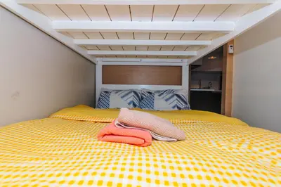 a bed with two towels sitting on top of it at Beauty Cindrella Home Makati Penthouse 3 Bedroom in Manila