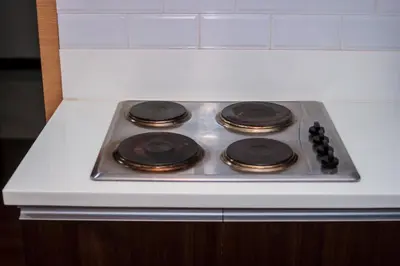 a stove top with four burners on top of it at Beauty Cindrella Home Makati Penthouse 3 Bedroom in Manila