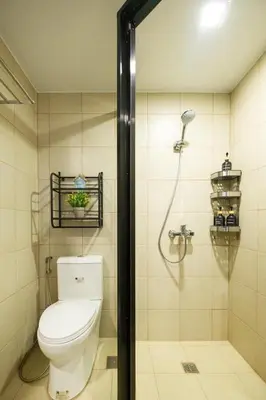 a bathroom with a toilet and a shower at Skyline Stay in Manhattan in Manila