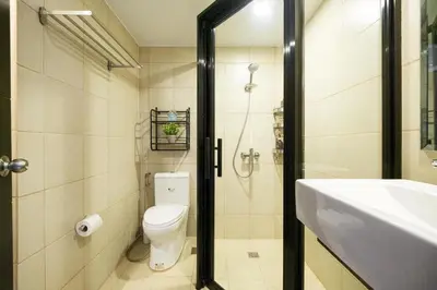 a bathroom with a toilet and a sink and a shower at Skyline Stay in Manhattan in Manila