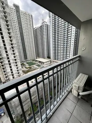 a balcony with a view of a city with tall buildings at Vince Cozy Staycation in Manila