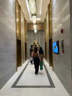 a group of people walking down a hallway in a building at Vince Cozy Staycation in Manila