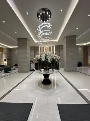 a lobby with a table with flowers on it at Vince Cozy Staycation in Manila