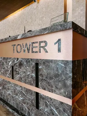 a sign that says tower on a wall at Oranje Suite Near Naia Terminal in Manila