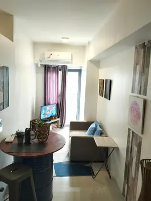 a living room with a table and a couch at Central Makati CBD in Manila