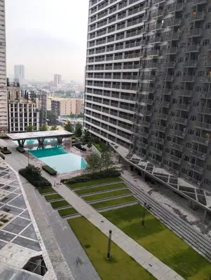 an aerial view of a large building with a swimming pool at Heart of Makati in Manila