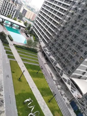 an aerial view of a park in front of a large building at Heart of Makati in Manila