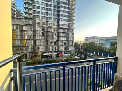 a balcony with a view of a large building at SEA RESIDENCES AFFORDABLE STAYCATIONs in Manila