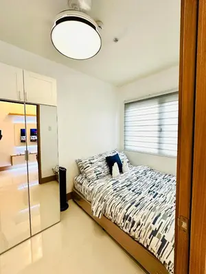 a bedroom with a bed and a large window at Urban Luxe Stay at Shore 3 in Manila