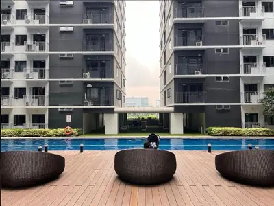 a dog sitting in a chair in front of a building at Urban Luxe Stay at Shore 3 in Manila