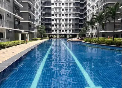 a large swimming pool in front of a building at Urban Luxe Stay at Shore 3 in Manila