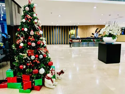 a christmas tree in a mall with presents under it at Urban Luxe Stay at Shore 3 in Manila