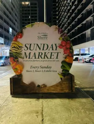 a sign for a sunday market with fruits and vegetables at Cozy Hearth Loft at Shore 3 in Manila