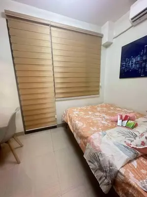 a bedroom with a bed and a large window at Nalin house SHORE 2 Residences in Manila