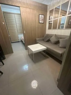 a living room with a couch and a table at Nalin house SHORE 2 Residences in Manila