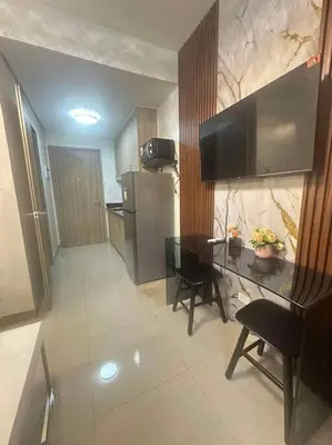 a kitchen with a table and chairs and a refrigerator at Nalin house SHORE 2 Residences in Manila