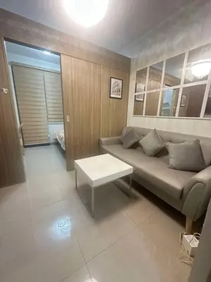 a living room with a couch and a table at Nalin house SHORE 2 Residences in Manila