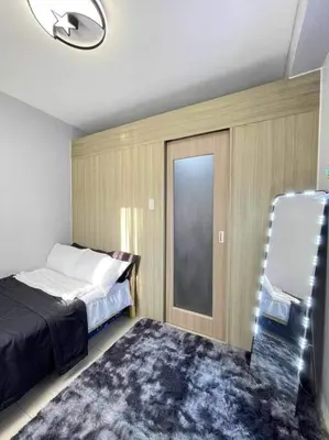 a bedroom with a bed and a window and a rug at Shore Residences Staycation by K in Manila