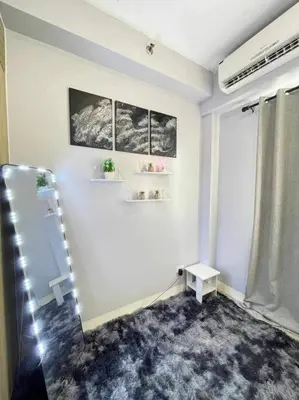 a white room with a shelf and a window at Shore Residences Staycation by K in Manila