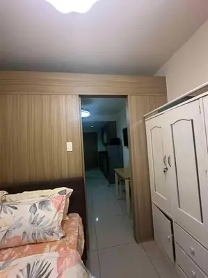 a bedroom with a bed and a door to a hallway at Cozy shore 1 residences in Manila