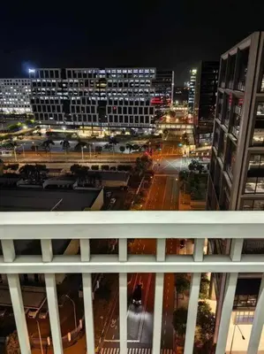 a view of a city at night with buildings at Shore Staycation - Mall of Asia in Manila
