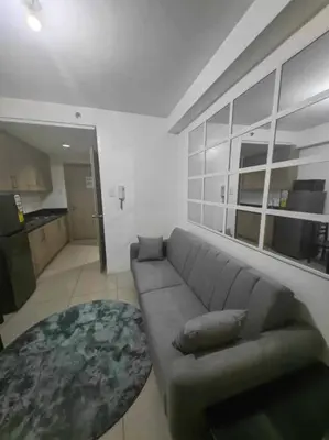 a living room with a couch and a table at Shore Staycation - Mall of Asia in Manila