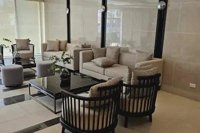 a living room with a couch and chairs and a table at 1BR self-contained CONDO in Makati with amenities! in Manila