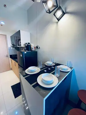 a kitchen with a counter with plates on it at Jazz Cozy Abode in Manila