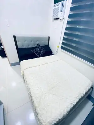 a small bed in a room with a window at Jazz Cozy Abode in Manila