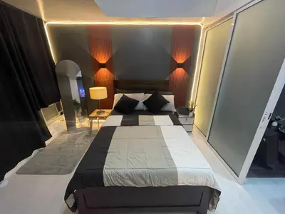 a bedroom with a large bed in a room at La Primera Deluxe in Manila