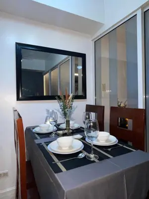 a dining room table with a blue table cloth and wine glasses at La Primera Deluxe in Manila