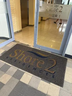 a welcome mat in front of a store door at Casa Antonietta at Shores Residences in Manila
