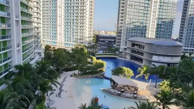 an aerial view of a pool in a city with tall buildings at Azure Urban Dream Staycation in Manila